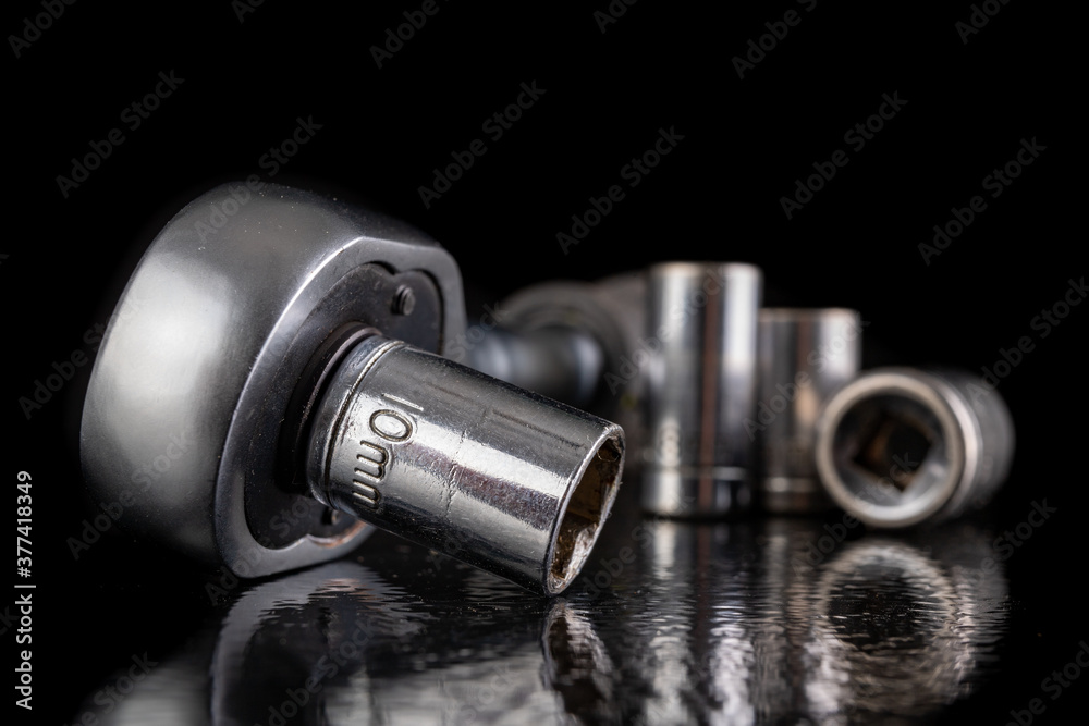 Metal socket wrenches and ratchet. Chromed repair tools in the workshop. Metal socket wrenches and ratchet. Chromed repair tools in the workshop.