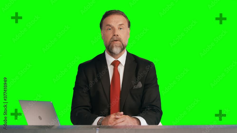 Green Screen Background: Live News Studio with Professional Male Anchor Reporting on the Events, Making Showing Gesture.Television Channel Newsroom Concept. Chroma Key Background with Tracking Markers Green Screen Background: Live News Studio with Professional Male Anchor Reporting on the Events, Making Showing Gesture.Television Channel Newsroom Concept. Chroma Key Background with Tracking Markers