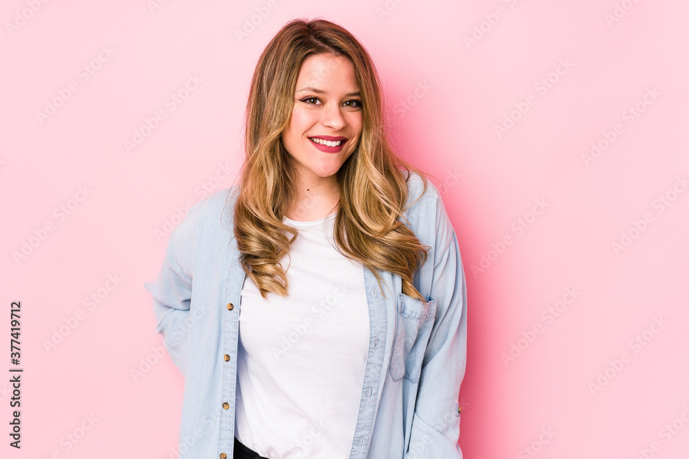 Young caucasian woman isolated on pink background happy, smiling and cheerful.