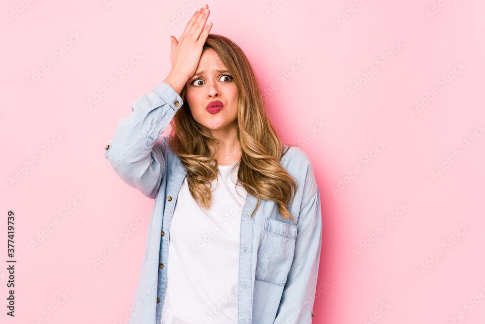 Young caucasian woman isolated on pink background forgetting something, slapping forehead with palm and closing eyes. Young caucasian woman isolated on pink background forgetting something, slapping forehead with palm and closing eyes.