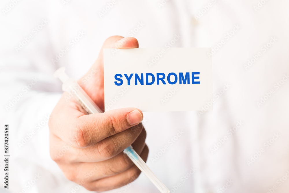 Word syndrome on a white background with a syringe in hand. Medicine and healthcare concept Word syndrome on a white background with a syringe in hand. Medicine and healthcare concept