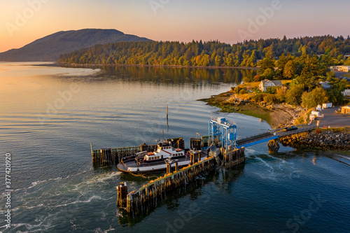 Overhead Aerial View of a Small Ferryboat docking on Lummi Island. The 21 car ferry services this small island near the city of Bellingham in the Salish Sea area of the Pacific Northwest.