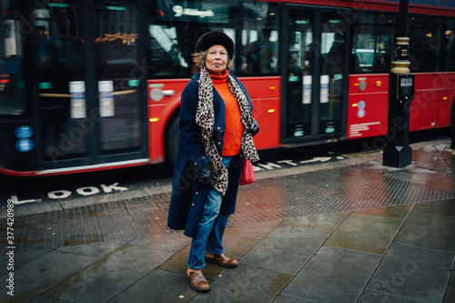 Older woman in front of bus, London