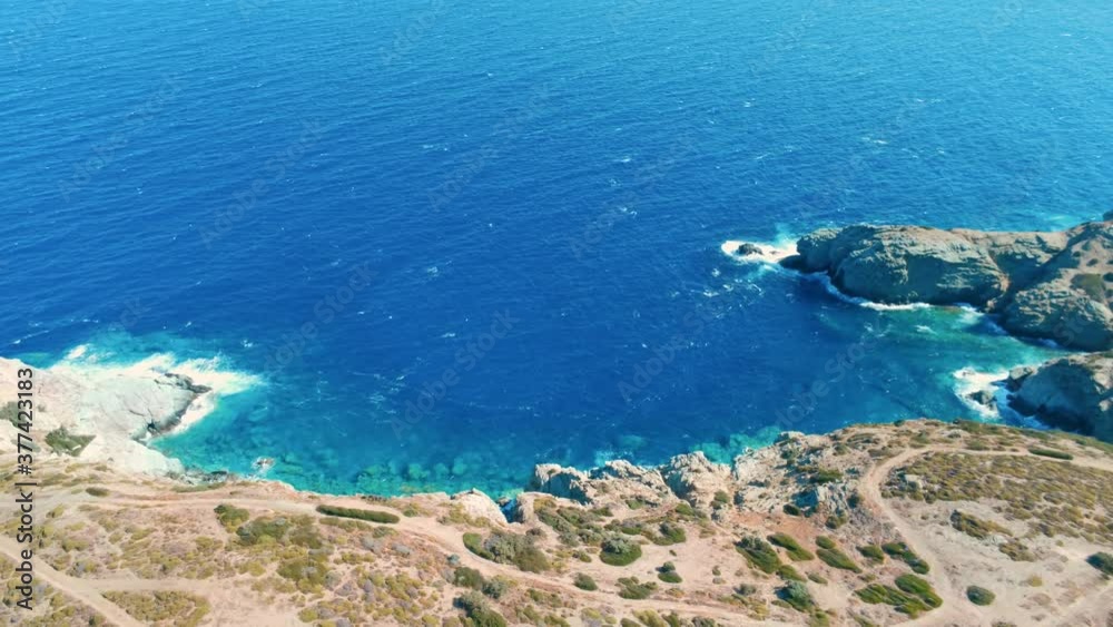 Aerial Nature Greek Landscape with Blue Sea Bay, Mountain and Rocks. Beautiful Vacation and Tourism Destination in Crete, Greece. Background Drone Pull Out Video Shot with Copy Space Aerial Nature Greek Landscape with Blue Sea Bay, Mountain and Rocks. Beautiful Vacation and Tourism Destination in Crete, Greece. Background Drone Pull Out Video Shot with Copy Space