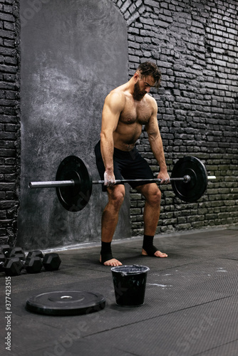 Handsome athlete gym training photo