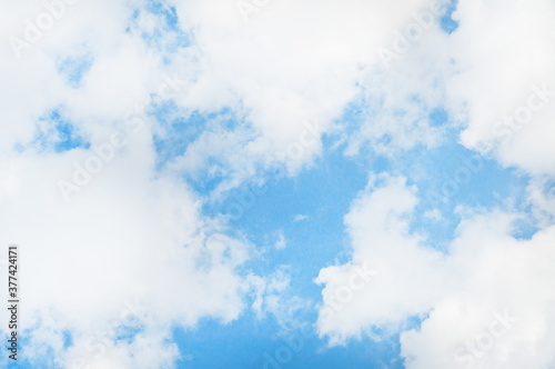 Bright blue sky background with tiny clouds. Sunny day