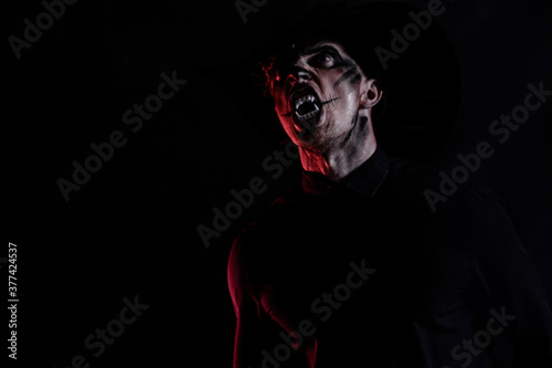 Halloween holiday celebration. Halloween man. Dark background.  © Erika