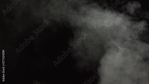 Soft Fog in Slow Motion on Dark Backdrop. Realistic Atmospheric Gray Smoke on Black Background. White Fume Slowly Floating Rises Up. Abstract Haze Cloud. Animation Mist Effect. Smoke Stream Effect 4K photo