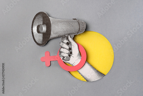 HAND HOLDING A BULLHORN WITH A FEMALE SIGN photo