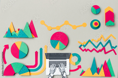 Female hands working on a laptop with a statistics papers