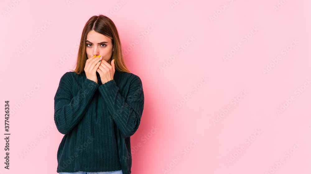 Young caucasian woman isolated on pink background covering mouth with hands looking worried. Young caucasian woman isolated on pink background covering mouth with hands looking worried.