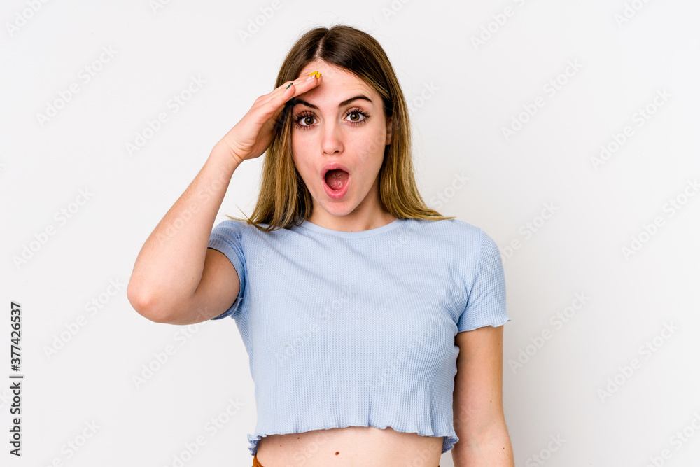 Young caucasian woman isolated on white background shouts loud, keeps eyes opened and hands tense. Young caucasian woman isolated on white background shouts loud, keeps eyes opened and hands tense.