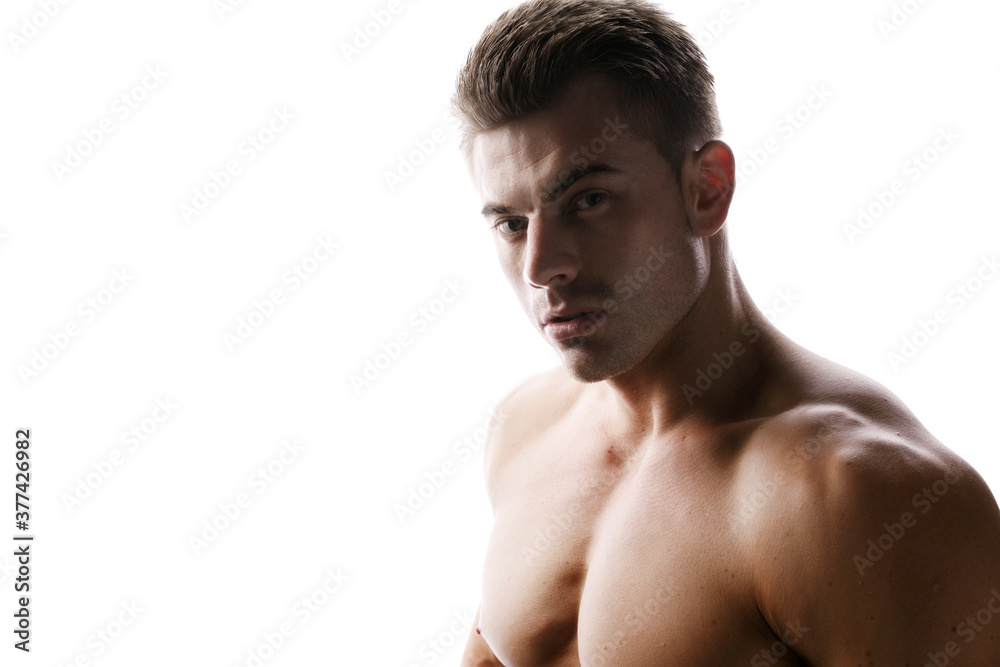 Muscular sexy model sports young man on white background. Portrait of beautiful healthy guy.