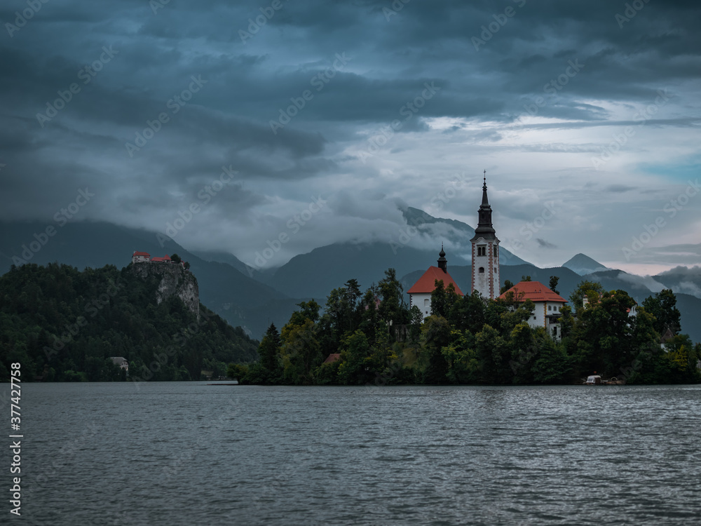 Lake Bled Slovenia. Beautiful mountain lake with small Pilgrimage Church. Most famous Slovenian lake and island Bled with Bled Castle in background.