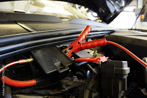 The red terminal is connected to a special connector of the car for charging the battery. 