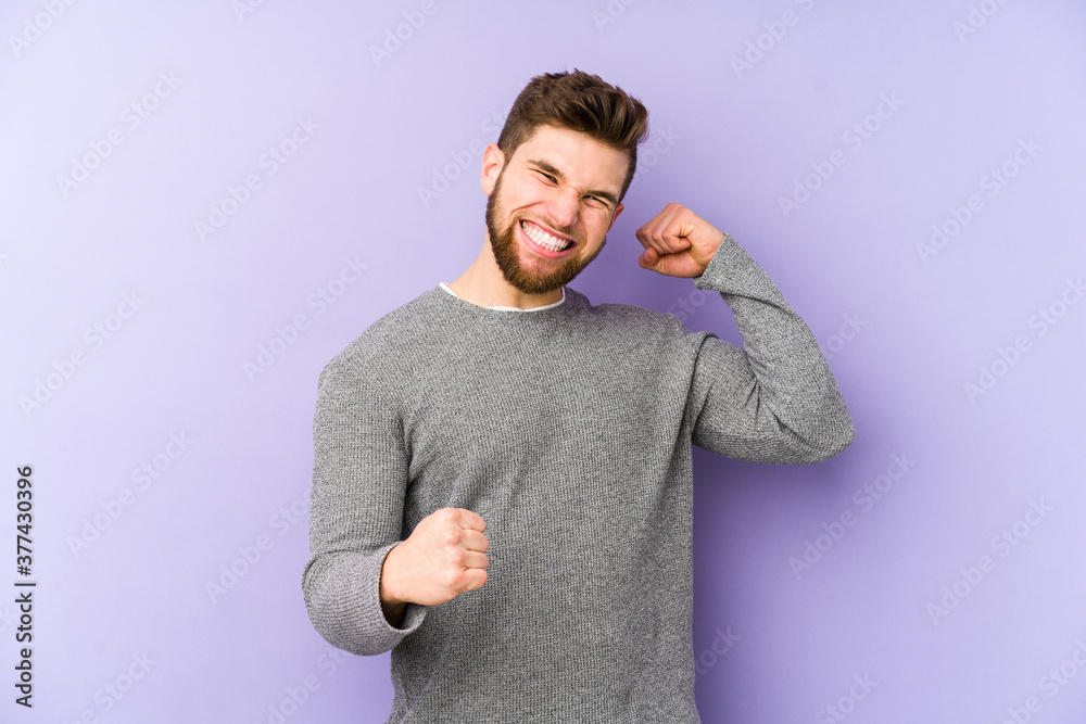 Φωτογραφία Young caucasian man isolated on purple background cheering carefree and excited