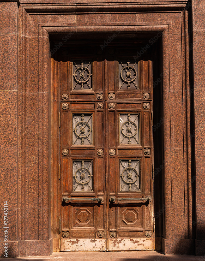 Facade of modern building. Old-fashioned brown front door. Facade of modern building. Old-fashioned brown front door.