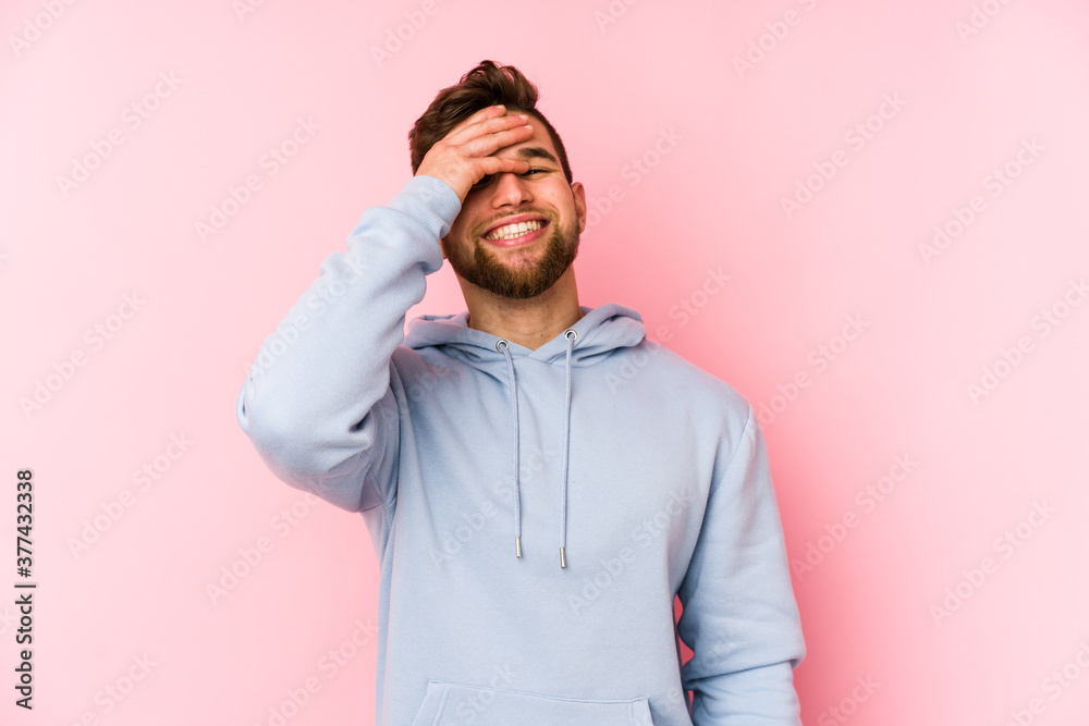 Young caucasian man isolated on pink background laughing happy, carefree, natural emotion. Young caucasian man isolated on pink background laughing happy, carefree, natural emotion.