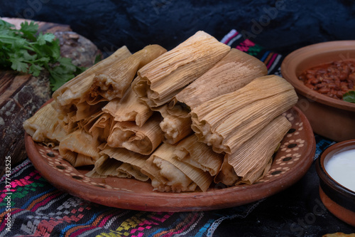 Canvas Print Vegan tamales filled with seitan, masa, chile verde and served with ranchero sau