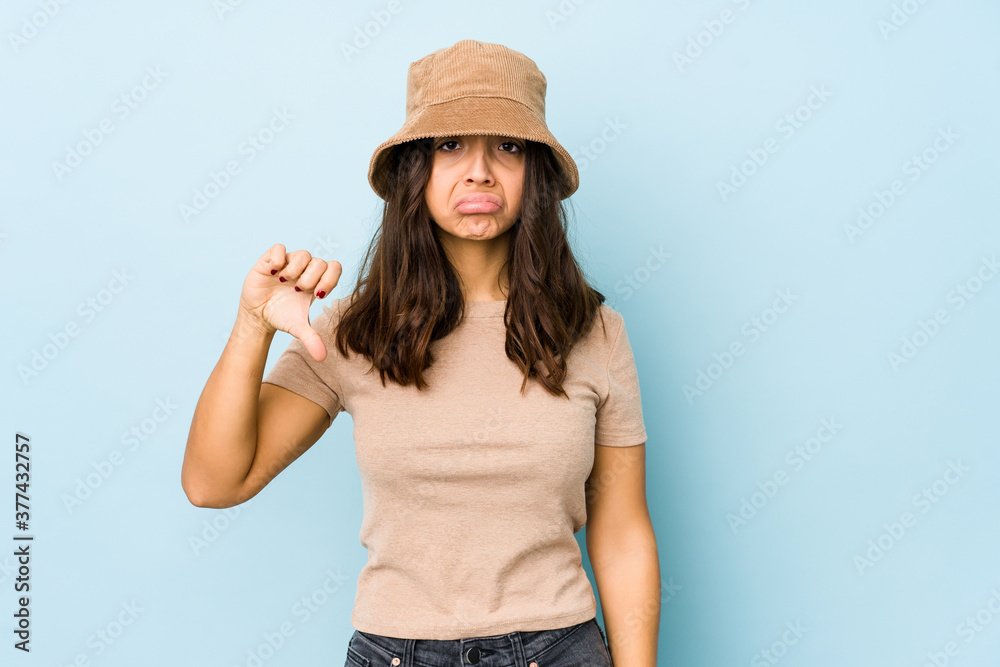 Young mixed race hispanic woman isolated showing thumb down, disappointment concept. Young mixed race hispanic woman isolated showing thumb down, disappointment concept.