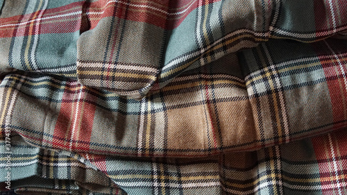 Multi colored tartan fabric background © Reed