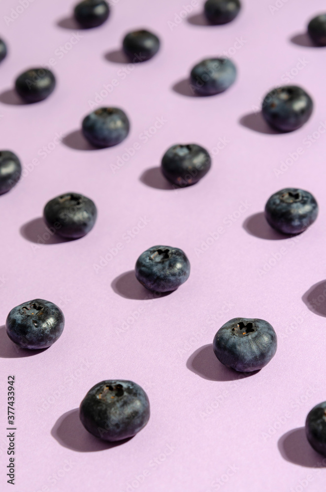 pattern of blueberries on violet background. Top view. Flat lay