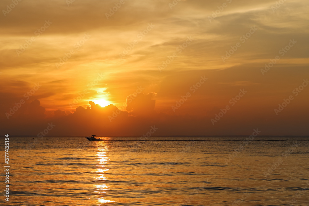 Boat Crossing Ocean at Sunset