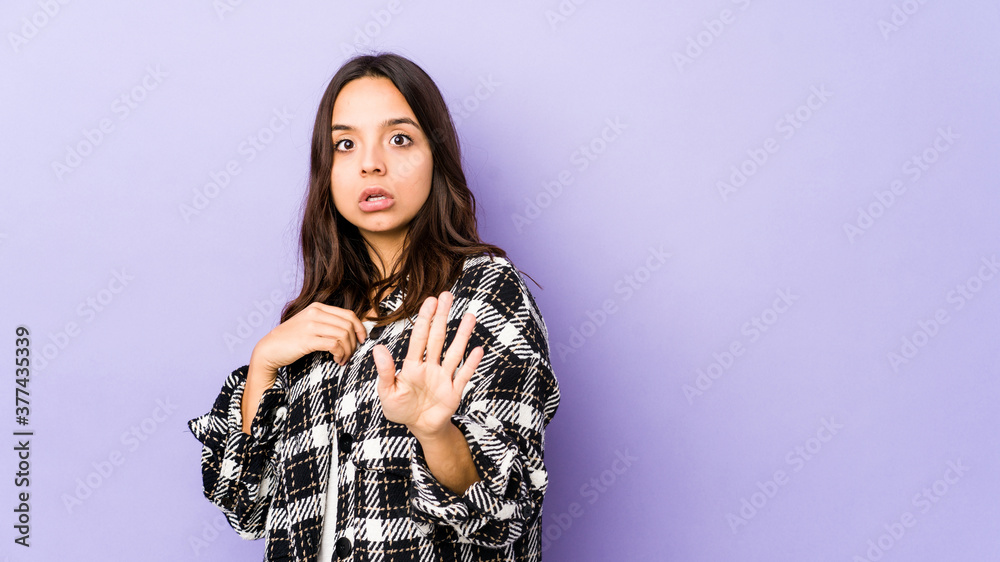 Young mixed race hispanic woman isolated being shocked due to an imminent danger Young mixed race hispanic woman isolated being shocked due to an imminent danger