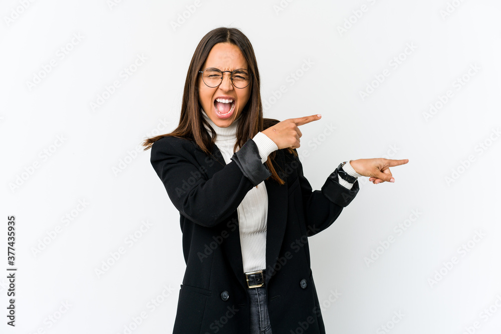 Young mixed race business woman isolated on white background excited pointing with forefingers away. Young mixed race business woman isolated on white background excited pointing with forefingers away.