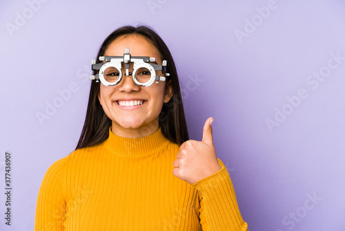 Youn indian woman with optometry glasses smiling and raising thumb up