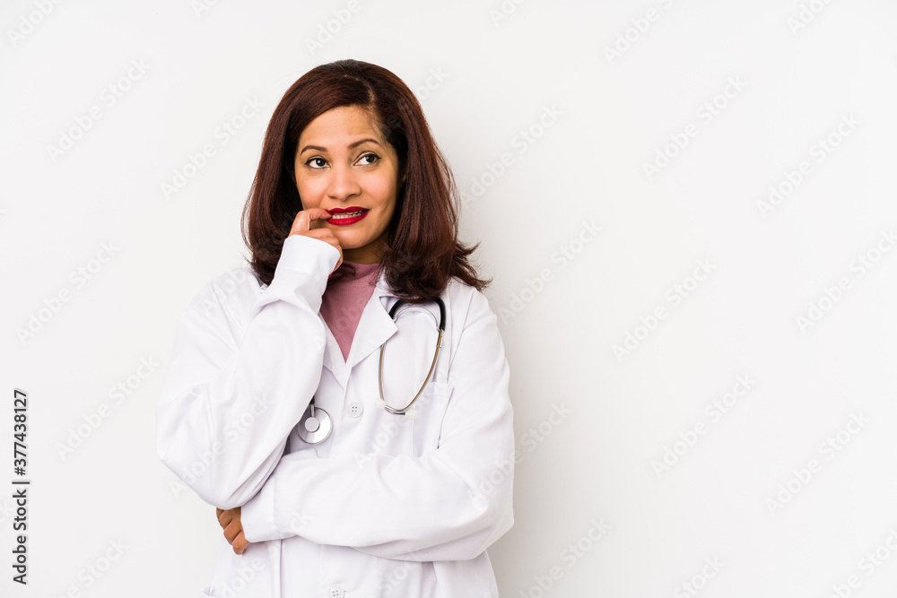 Middle age latin doctor woman isolated relaxed thinking about something looking at a copy space. Middle age latin doctor woman isolated relaxed thinking about something looking at a copy space.