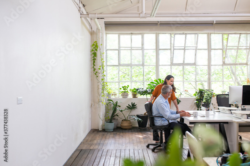 Man and woman meeting in an urban renovated white heritage office space