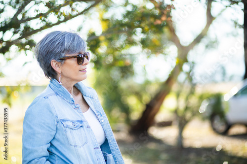 Senior woman looking away outside in natural setting photo