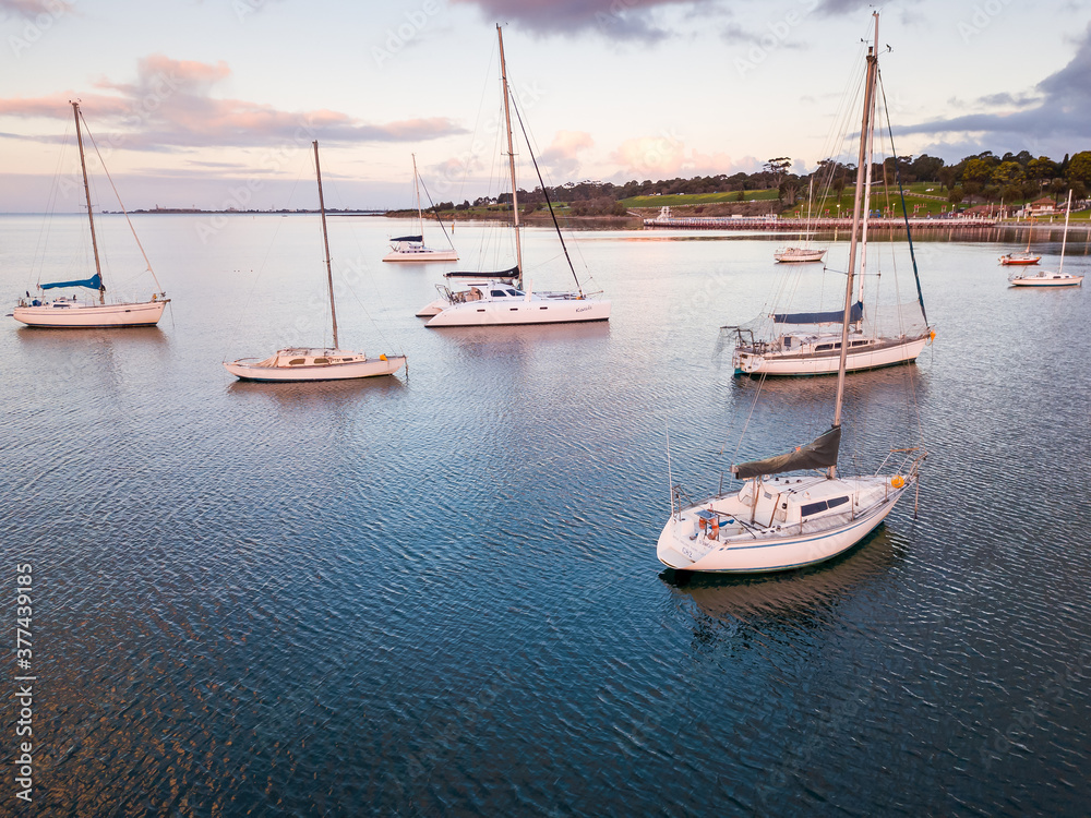 Looking down on yachts anchored in a bay on a calm evening Looking down on yachts anchored in a bay on a calm evening