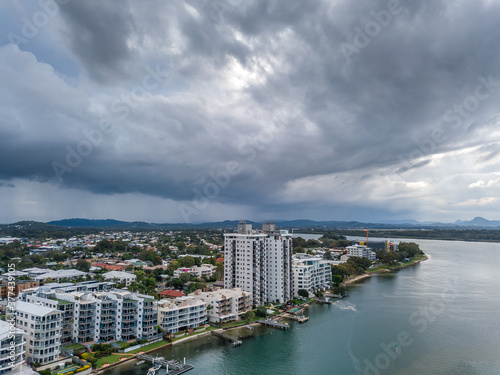Aerial view of hi rise buildings on a waterfront under dark storm clouds