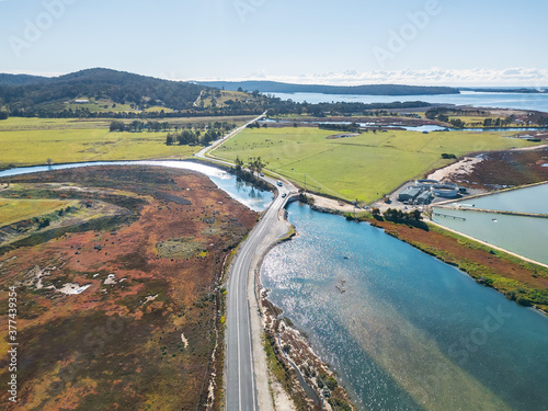 Looking down on a road crossing a river and going off into the distance photo