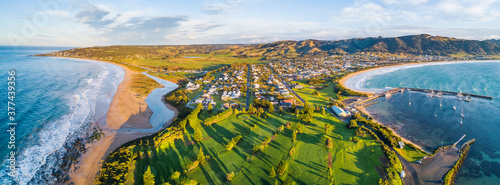 Aerial view a golf course and coastal town with ocean on both sides