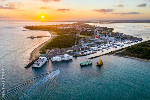 Aerial view of a ferry terminal and boats at a marina at sunset photo