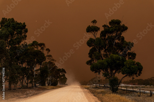 dust storm blowing in over dirt road photo