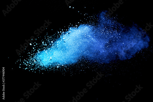 Closeup of blue dust particle splash isolated on black background.