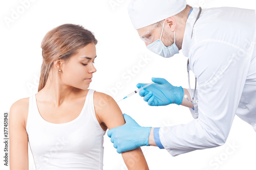 Doctor gives a syringe with vaccine to patient at clinic.