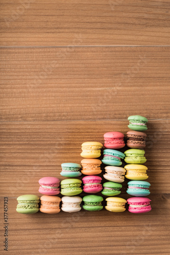 Colorful French macaron top view arrange in graph shape on wood background