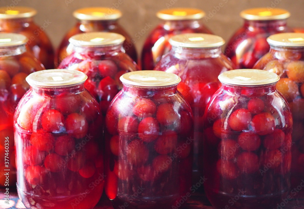 Preservation for the winter is in the pantry or cellar.Large glass jars with home preservation of plum compote. Preservation for the winter is in the pantry or cellar.Large glass jars with home preservation of plum compote.