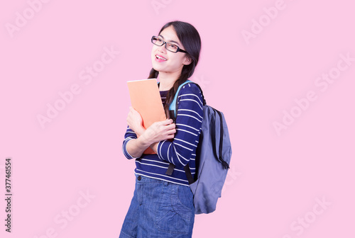 Back to school and happy time! Cute industrious child is Isolated on pink background. Kid with backpack. Girl ready to study.