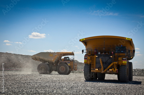 Large trucks transport gold ore from open cast mine. Barrick Cowal Gold Mine in New South Wales, Australia. photo