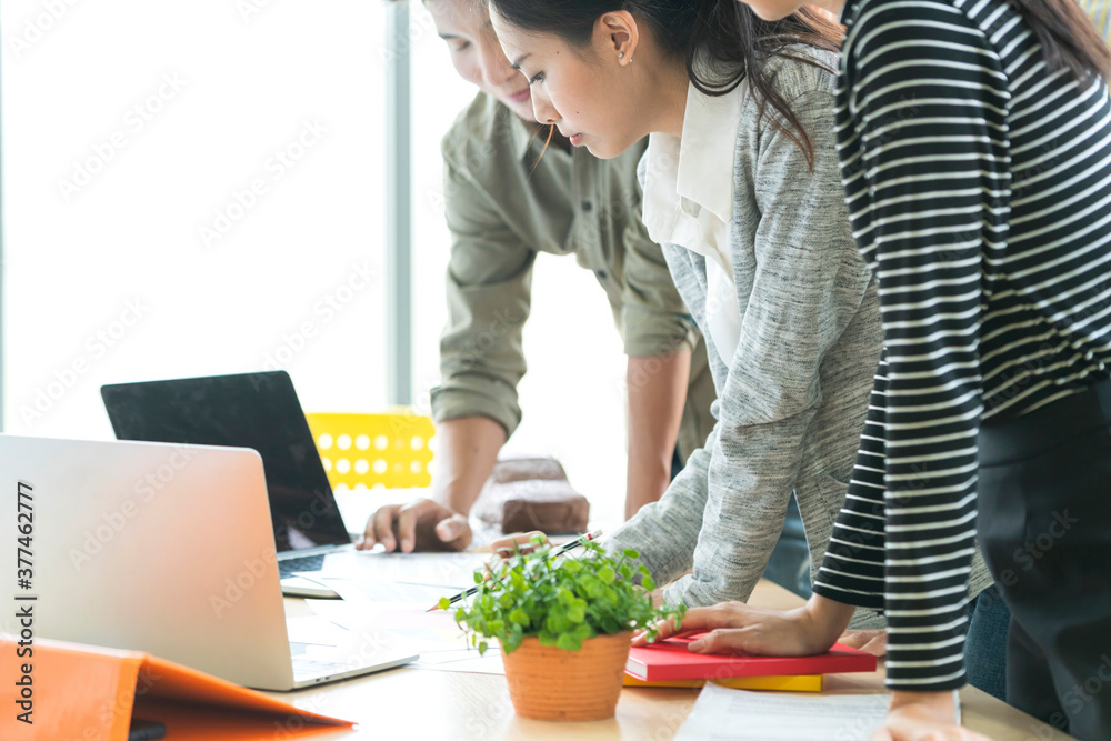Cropped shot of a asian teamwork group of businesspeople using a digital tablet laptop during a meeting in a modern office Cropped shot of a asian teamwork group of businesspeople using a digital tablet laptop during a meeting in a modern office