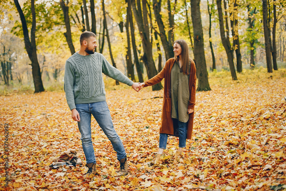 Couple in a park. Woman in a brown sweater. Man with a beard Couple in a park. Woman in a brown sweater. Man with a beard