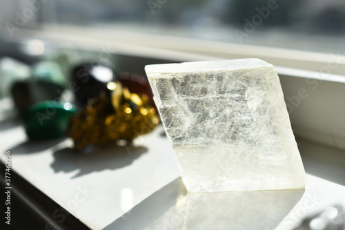An image of clear Icelandic Spar calcite charging on a white window ledge. photo