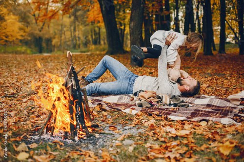 Family with cute little daughter. Father in a white sweater