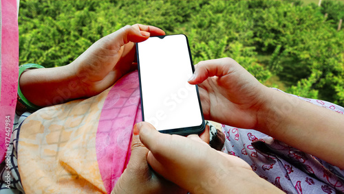 mother and daughter looking at smartphone holding in hands together